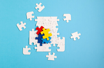Naklejka premium Autism Awareness Day, World Autism Day, April 2. Colorful and White Puzzles on Blue Background