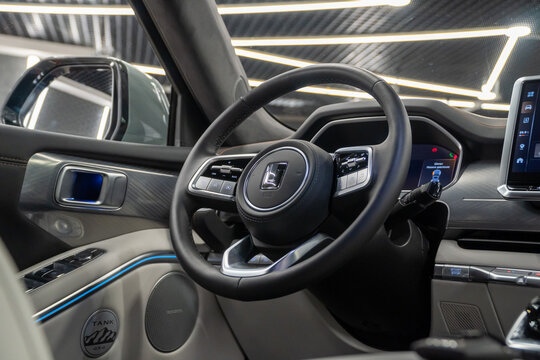 Luxury interior of Tank 700 Е1 Edition One V6 Hybrid 4WD. White, black leather interior, steering wheel, dashboard, gear shifting, armrest, front seat. Chinese automobile brand, of Great Wall Motors.