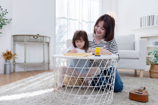 Mother and child engage in creative play at home during afternoon hours