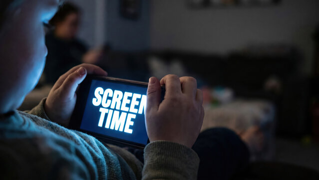 Child's Obsession with Digital Device During Screen Time in a Dark Room