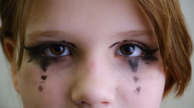 Close‑up shot captures a girl&rsquo;s mesmerizing eye, framed by dramatic stage makeup. Face paint. Performance on stage. Close‑up captures a girl&rsquo;s eye in the quiet moments before the curtain rises.