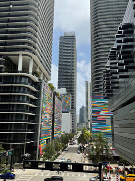 Miami, FL, USA, June 27, 2025: Car movement at the intersection of Brickell Plaza with S Miami Ave from the Brickell City Centre, Brickell Heights and SLS Lux rainbow stripped mural in background.