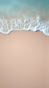 Turquoise ocean waves gently washing onto a pristine sandy beach, seen from a top aerial view, creating a tranquil natural backdrop for relaxation and summer holidays