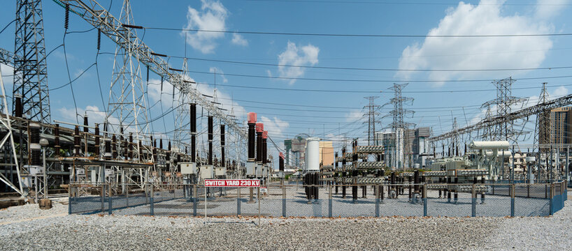 Power Station Infrastructure with High Voltage Lines and Equipment Under Blue Sky