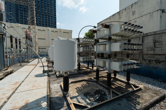 Industrial Power Equipment and Transformers in Urban Setting Under Clear Blue Skies