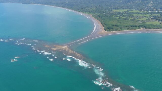 Stunning aerial perspective of the famous whale tail shaped tombolo at Marino Ballena National Park in Uvita, Costa Rica, during low tide