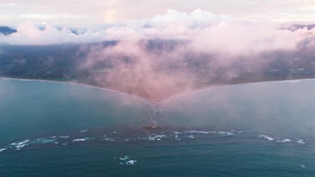 Majestic aerial perspective of the iconic whale tail shaped tombolo at Marino Ballena National Park in Uvita, Costa Rica during sunset