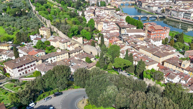 Aerial drone view Florence Lungarni Arno River banks with historic buildings colorful facades Ponte Vecchio and Tuscan cityscape