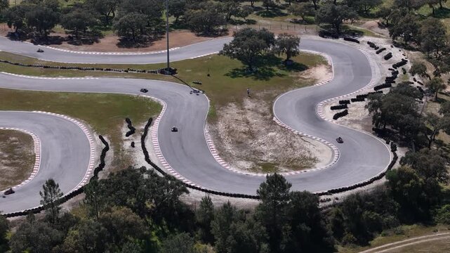 Palmela, Portugal - 01 April 2026: Aerial view of KIP - Kartodromo Internacional de Palmela with go-karts racing on the winding asphalt track surrounded by green trees.