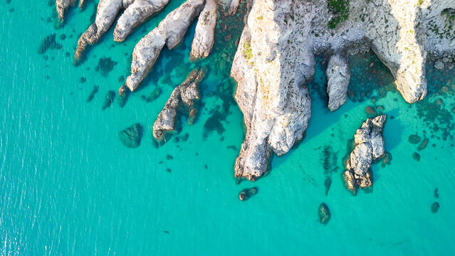 Breathtaking summer aerial panorama of Calabria's Capo Vaticano coastline, showcasing dramatic white cliffs plunging into the crystal-clear turquoise waters