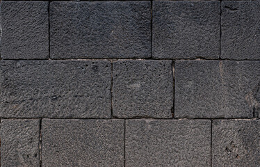 Fototapeta premium Volcanic stone wall texture of 1600s castle for design backgrounds