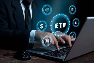 Naklejka premium Businessman using laptop with ETF (Exchange Traded Funds). Investment Opportunities in Mutual Funds and ETFs, Growing Wealth in the Financial Market.