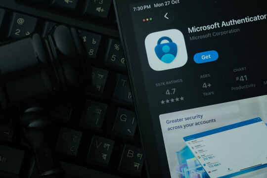Dhaka, Bangladesh- 28 Oct 2025: An iPad displaying the Microsoft Authenticator app against a judge's gavel and dark keyboard background.