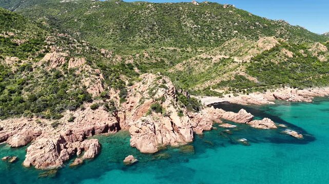 Aerial view of Su Sirboni Beach, Marina di Gairo, Sardinia, Italy. Turquoise sea, rugged red cliffs and hidden coves along the wild Ogliastra coastline
