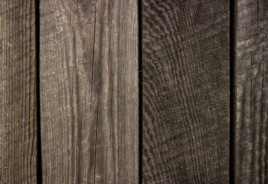 Natural dark weathered wood planks texture background.