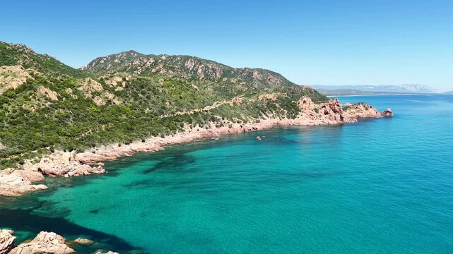 Aerial view of Su Sirboni Beach, Marina di Gairo, Sardinia, Italy. Turquoise sea, rugged red cliffs and hidden coves along the wild Ogliastra coastline
