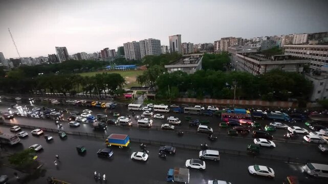 High Angle View of Dense Traffic Congestion on a Multi-Lane Urban Highway During a Rainy Twilight in a Bustling Asian Metropolis