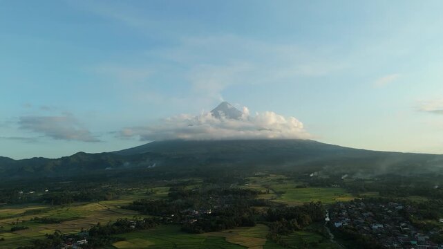 Distant Mayon Volcano looms under soft sky. Cinematic Landscape