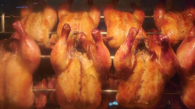 Rotisserie chickens roasting in an oven, Grilled chicken in steamy rotisserie oven machine, golden crispy skin, juicy texture with heat. Perfect for food, street food, cooking, restaurant concepts
