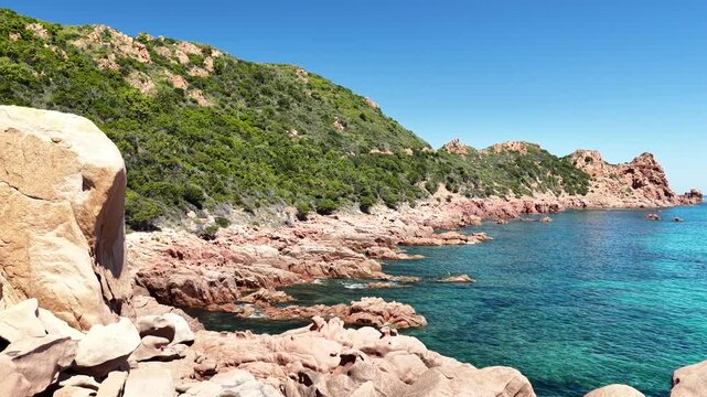 Aerial view of Su Sirboni Beach, Marina di Gairo, Sardinia, Italy. Turquoise sea, rugged red cliffs and hidden coves along the wild Ogliastra coastline