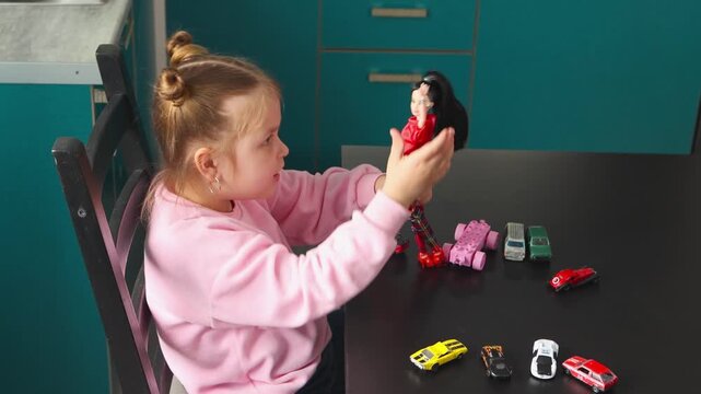 Top view of preschool Caucasian child is building stories with dolls and play sets at a table. Early childhood play encourages creativity, problem solving, and concentration.