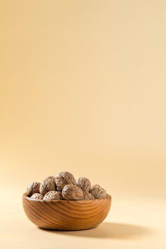 Minimalist Composition of Whole Walnuts in Wooden Bowl