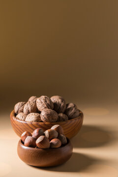 Hazelnuts and Walnuts in Wooden Bowls Vertical