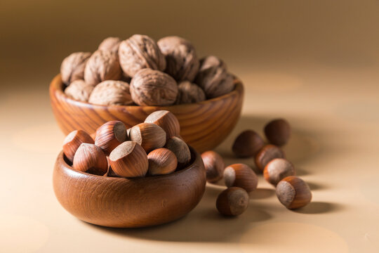 Hazelnuts and Walnuts in Wooden Bowls