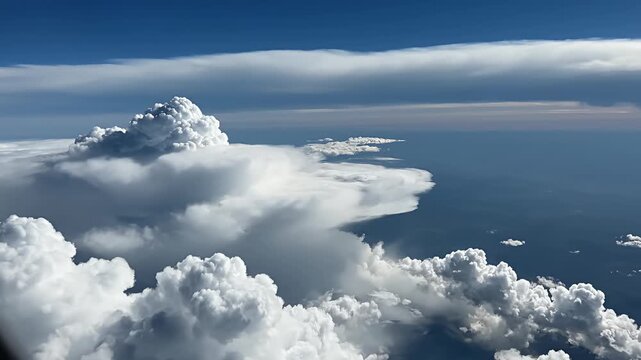 Aerial view of massive white cumulus clouds above horizon