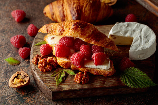 Croissant with camembert cheese, raspberries and walnuts.