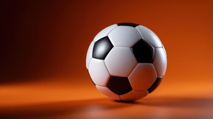 Naklejka premium Classic soccer ball on vibrant orange background with dramatic lighting