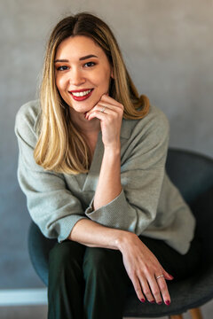 Confident businesswoman smiling in modern interior, showcasing leadership, professionalism, success