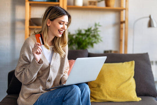 Woman managing finances through online banking with a credit card and laptop at home