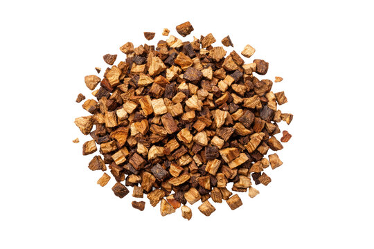 Dried chicory root pieces, a pile of roasted chicory for coffee substitute or herbal tea. Natural brown chicory ingredient, healthy beverage component, and digestive aid.