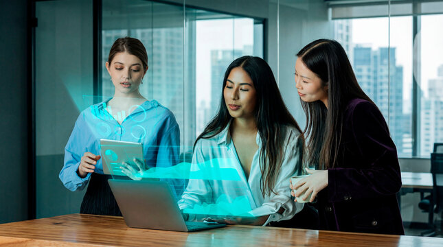 Business women reviewing digital reports on tablet and laptop