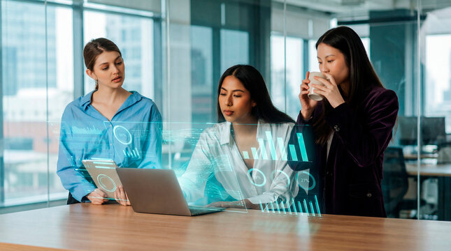 Professional women evaluating performance charts on digital display