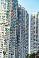 Fototapeta premium A dense cluster of high-rise residential buildings in Hong Kong, showcasing the city’s iconic urban density. 