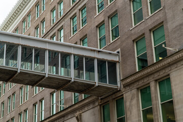 Architectural detail of historic Joseph Horne Co. building in Downtown Pittsburgh, featuring ornate facade, numerous windows, and a connecting pedestrian skywalk. © Michael