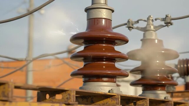 High voltage insulators on a metal rack outdoors