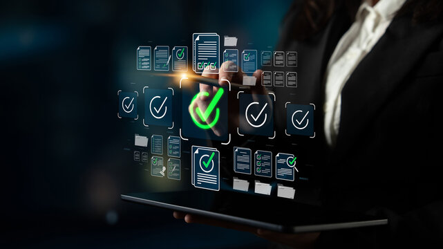 Business professional using digital tablet to validate documents with approval symbols and technology interface in modern office background Sigmoid