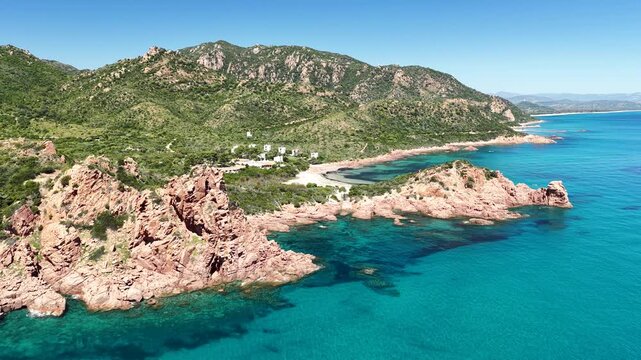 Aerial view of Su Sirboni Beach, Marina di Gairo, Sardinia, Italy. Turquoise sea, rugged red cliffs and hidden coves along the wild Ogliastra coastline