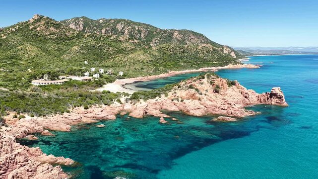 Aerial view of Su Sirboni Beach, Marina di Gairo, Sardinia, Italy. Turquoise sea, rugged red cliffs and hidden coves along the wild Ogliastra coastline