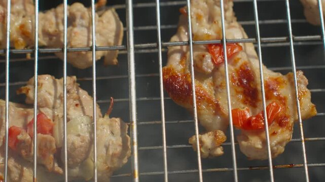 Grilled Chicken Pieces On Metal Rack, Closeup With Smoky Char And Red Pepper Glaze, Sizzling Juices And Golden Sear Visible Through Wire Grate, Backyard Barbecue Vibe With Warm Heat And Appetizing