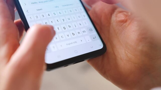 Female hands typing text on smartphone close-up.