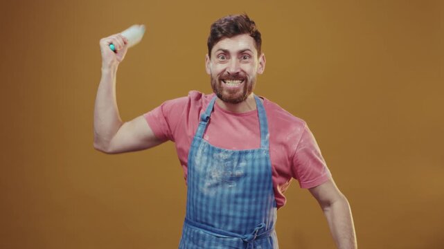 Vibrant studio scene featuring lively male chef demonstrating baking skills with enthusiasm and flair