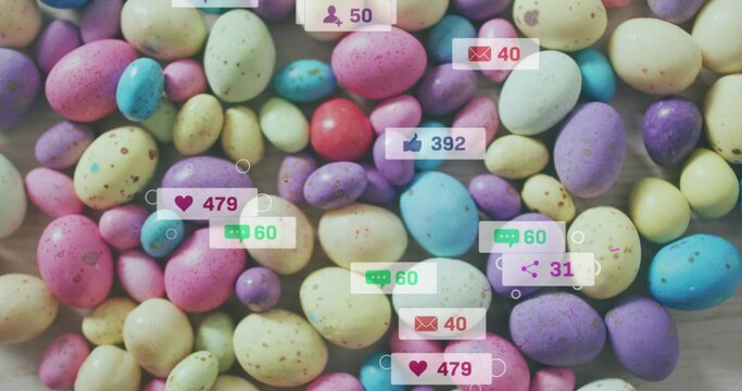 Covering dense cluster of pastel speckled candy eggs on light wood tabletop, showing social badges