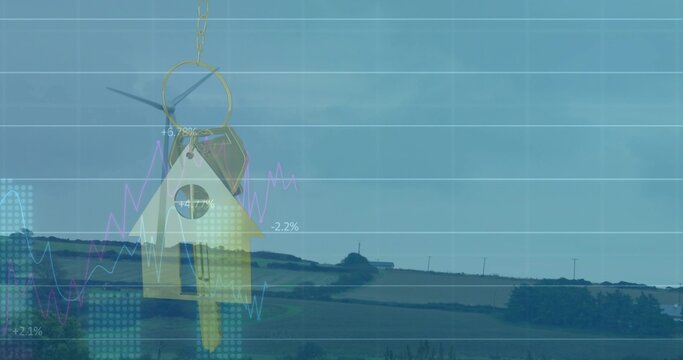 Hanging house-shaped key fob dangling over rural fields, showing brass key and financial charts