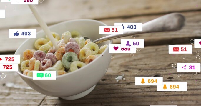 Pouring milk into white bowl of colorful cereal, wood table, spoon right, social badges, copy space