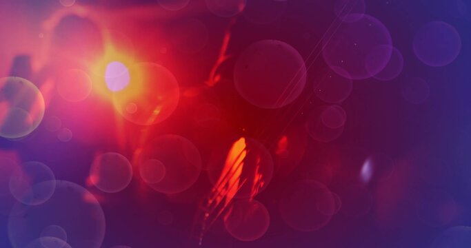 Glowing ambiguous silhouette and overlapping bokeh filling dark studio, with warm orange-red light