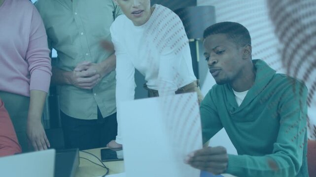 Seated business lead raising sheet and explaining while team leaning in, patterned overlay shifting